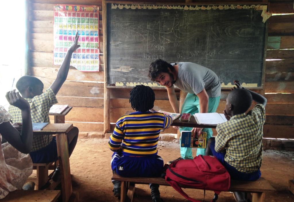 Volunteer helping children learn in a rural classroom