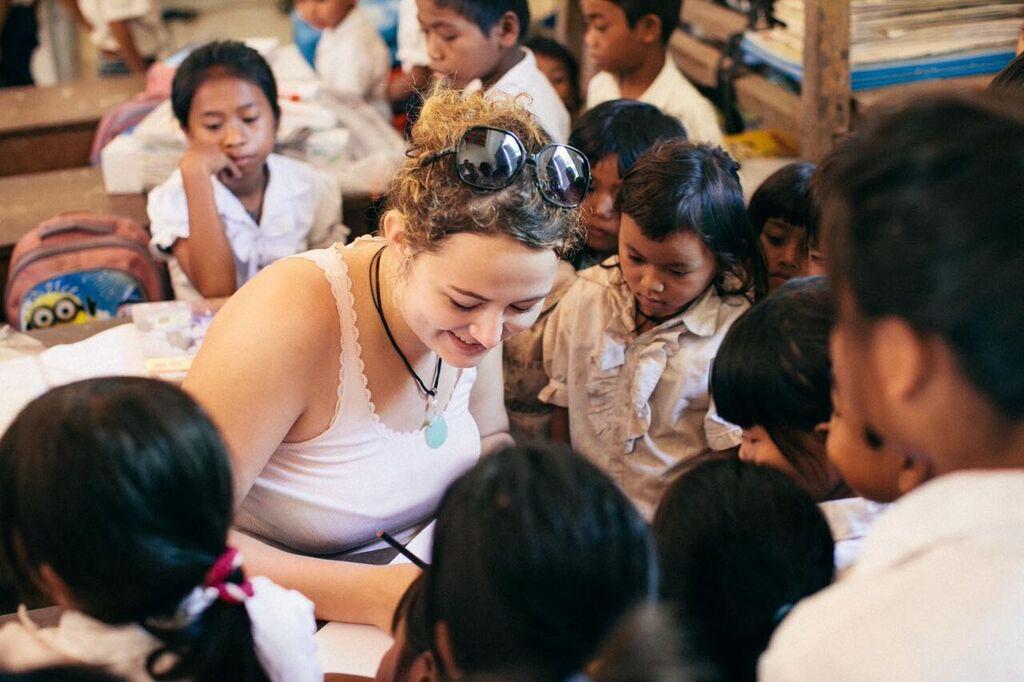 Volunteer working with children during a classroom activity