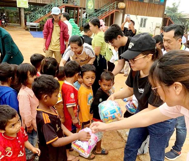 Volunteers distributing supplies to children in a community